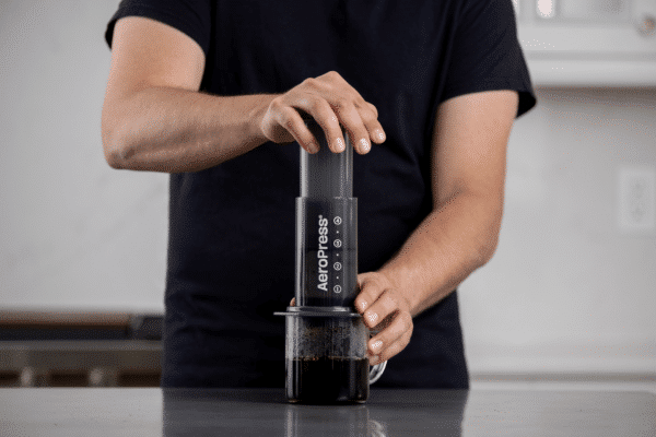 Person brewing coffee with AeroPress