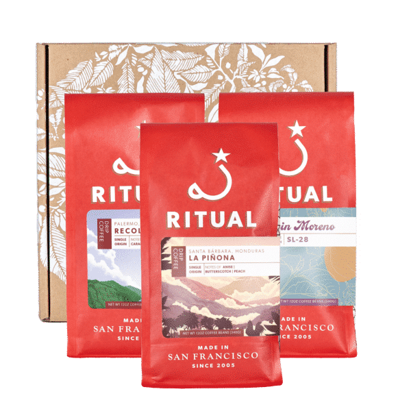 Three 12 ounce bags of coffee with a cardboard box
