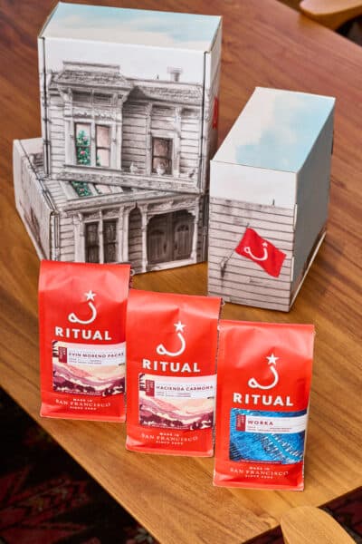 3 bags of drip coffee with gift boxes on top of a wooden table