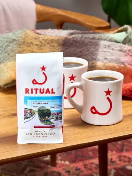 12oz bag of espresso with mugs on a wooden table