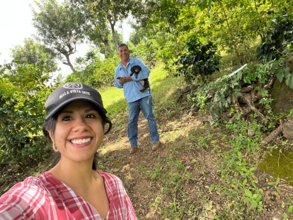 Melania Herrera and Fidel Raxcacó holding a puppy at the coffee farm